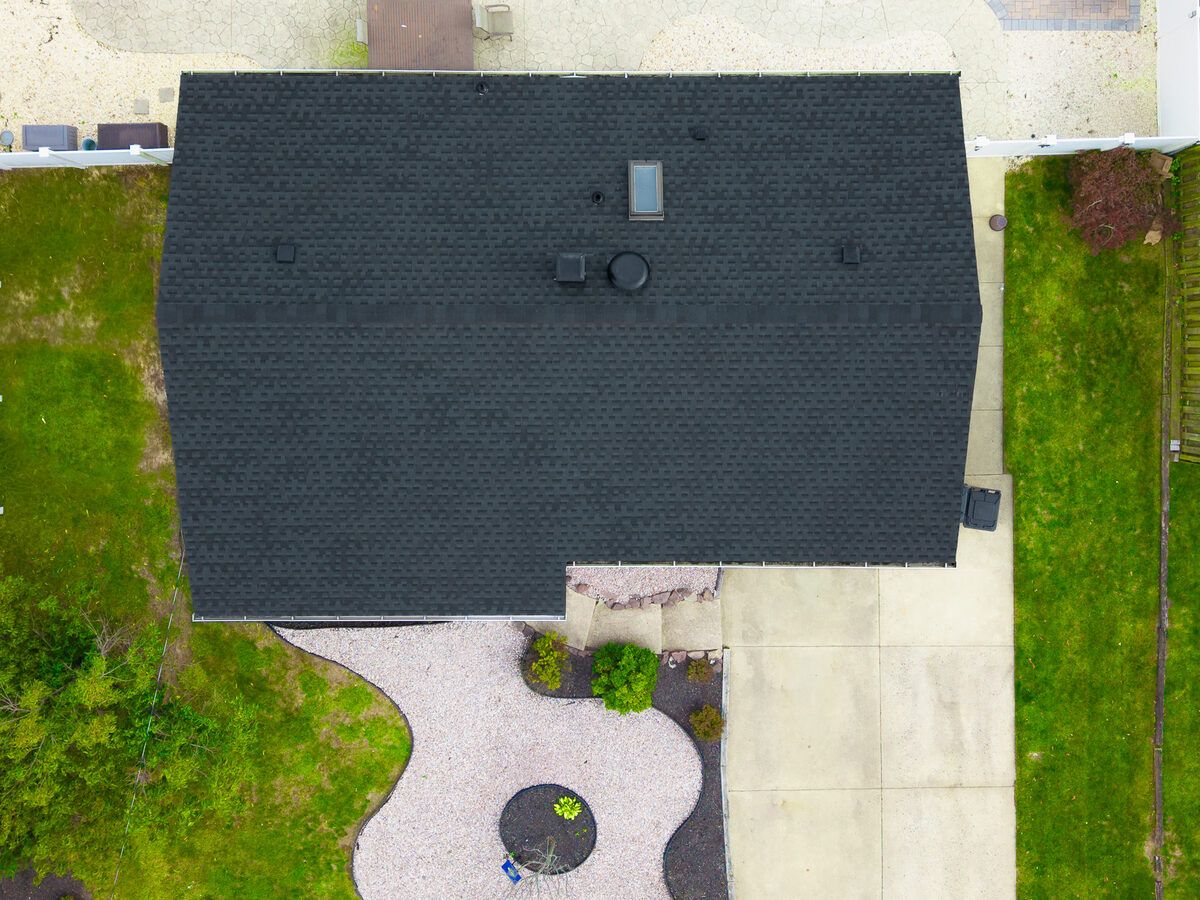 Completed roof replacement with crisp ridge lines on a Jersey Shore home